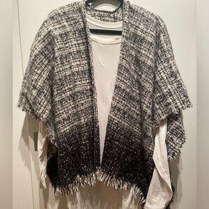 Black and ivory woven poncho.  27” shoulder to bottom.